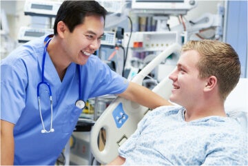 Male nurse smiling at male patient