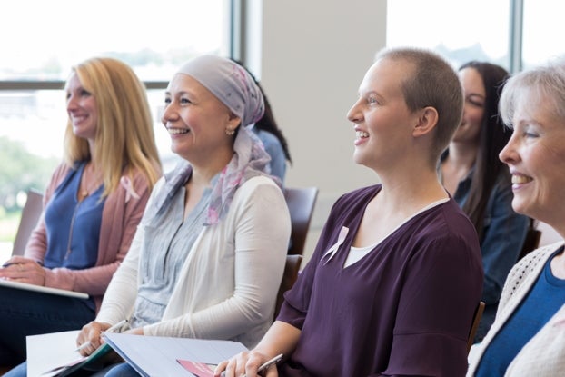 A group of woman in the audience smiling during a presentation
