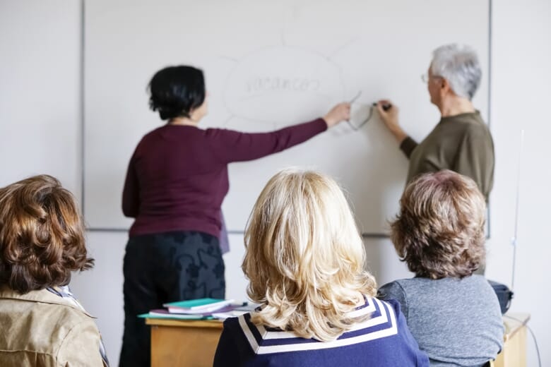 Older adults learning Spanish in a classroom 